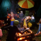 The Straw Hats eat food and trade stories over a campfire.